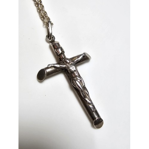 280 - A sterling silver Crucifix pendant set on a long 19