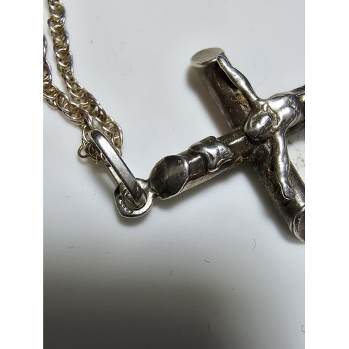 280 - A sterling silver Crucifix pendant set on a long 19