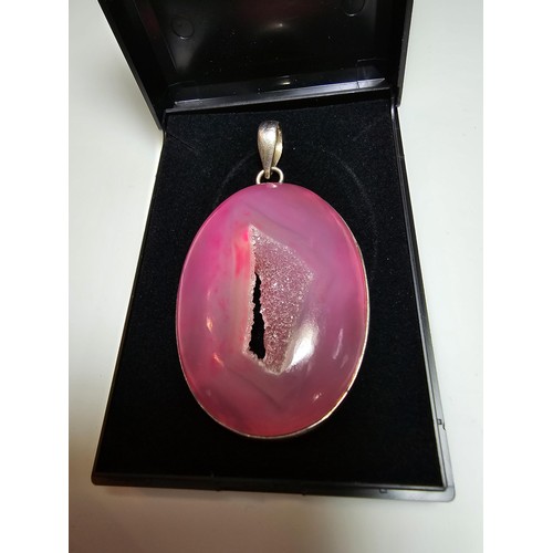 283 - A large 925 silver pendant inset with a large natural dyed pink crystal along with a Stanley London ... 