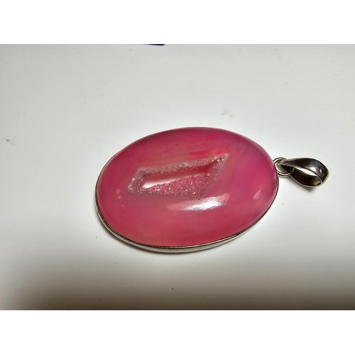 283 - A large 925 silver pendant inset with a large natural dyed pink crystal along with a Stanley London ... 