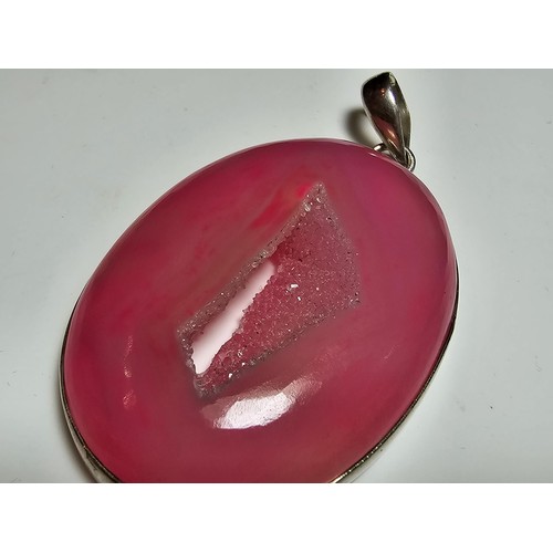 283 - A large 925 silver pendant inset with a large natural dyed pink crystal along with a Stanley London ... 