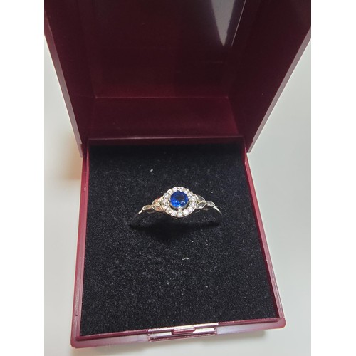 291 - A new and unused 925 silver dress ring inset with a sparkly blue crystal CZ stone and clear CZ stone... 