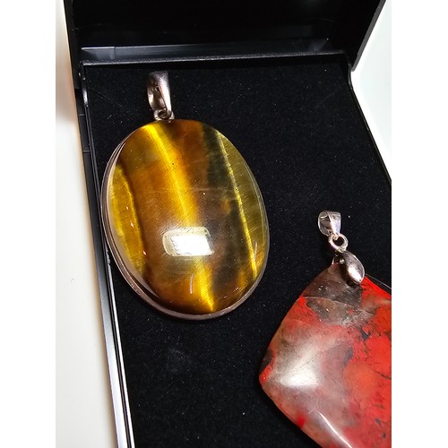 294 - 2 good quality 925 silver semi precious stone pendants to include a large oval tigers eye pendant an... 