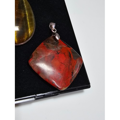 294 - 2 good quality 925 silver semi precious stone pendants to include a large oval tigers eye pendant an... 