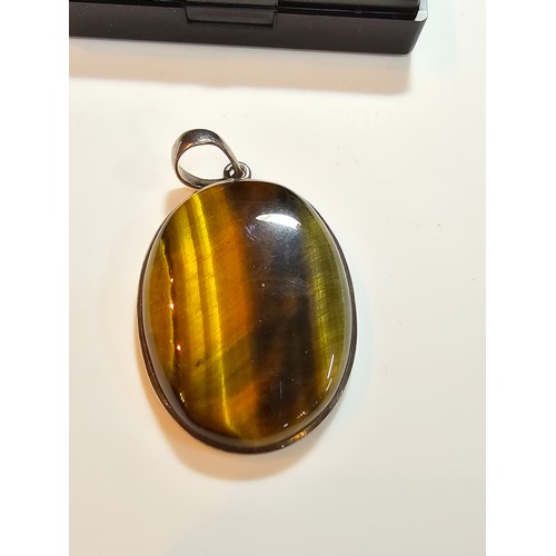 294 - 2 good quality 925 silver semi precious stone pendants to include a large oval tigers eye pendant an... 