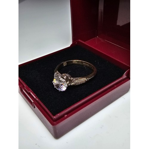 296 - A good quality gold and silver solitaire dress ring featuring a large sparkly crystal CZ stone, full... 