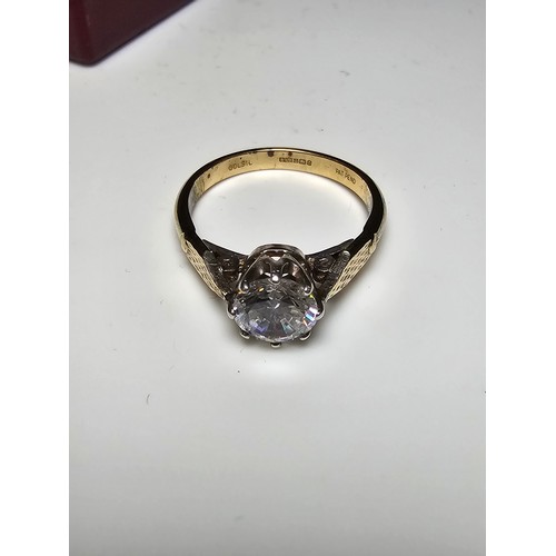 296 - A good quality gold and silver solitaire dress ring featuring a large sparkly crystal CZ stone, full... 