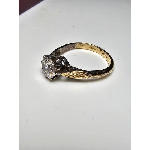 296 - A good quality gold and silver solitaire dress ring featuring a large sparkly crystal CZ stone, full... 