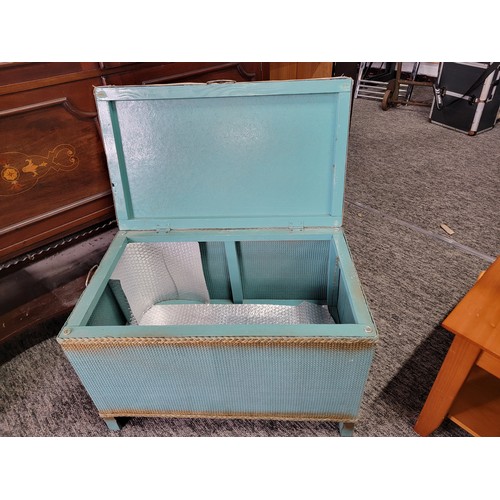 426 - Vintage lloyd loom style blanket box with padded blue floral seat to the top and metal carry handles... 