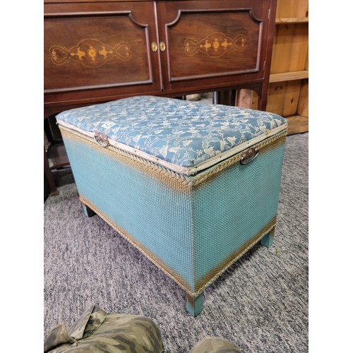 426 - Vintage lloyd loom style blanket box with padded blue floral seat to the top and metal carry handles... 