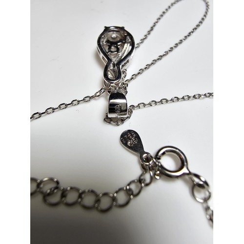 298 - A new and unused pretty 925 silver pendant inset with 2 sparkly CZ crystal stones on an 18