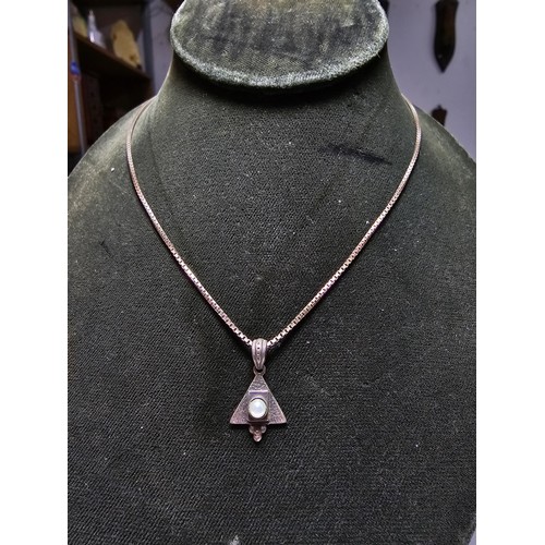 299 - An unusual 925 silver triangular pendant inset with a genuine pearl on a good long 20