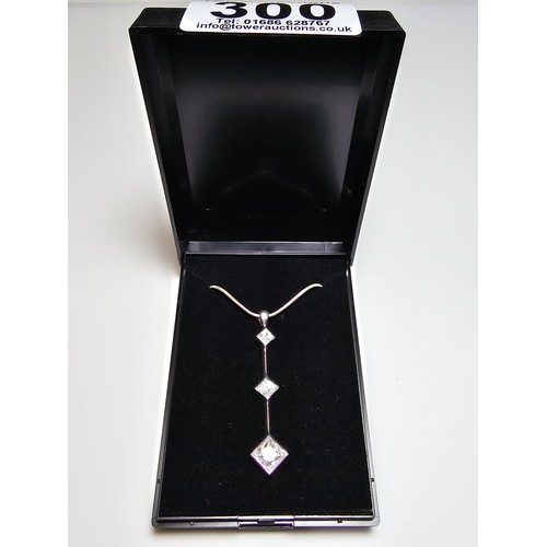 300 - A long drop 925 silver pendant inset with 3 sparkly crystal CZ stones on a 16