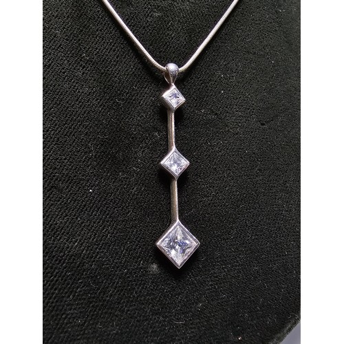 300 - A long drop 925 silver pendant inset with 3 sparkly crystal CZ stones on a 16