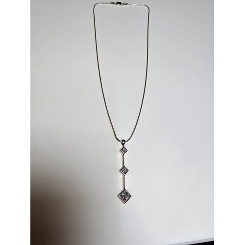 300 - A long drop 925 silver pendant inset with 3 sparkly crystal CZ stones on a 16