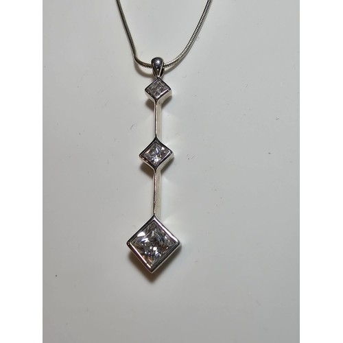 300 - A long drop 925 silver pendant inset with 3 sparkly crystal CZ stones on a 16