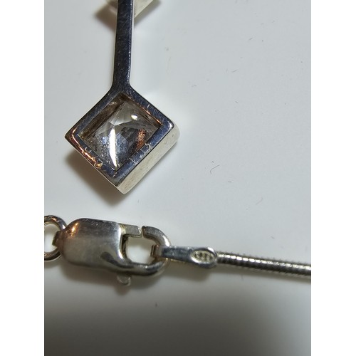 300 - A long drop 925 silver pendant inset with 3 sparkly crystal CZ stones on a 16