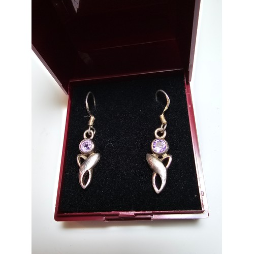 301 - A pair of 925 silver drop earrings inset with amethyst stones. In excellent clean condition and boxe... 