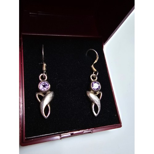 301 - A pair of 925 silver drop earrings inset with amethyst stones. In excellent clean condition and boxe... 