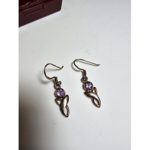 301 - A pair of 925 silver drop earrings inset with amethyst stones. In excellent clean condition and boxe... 