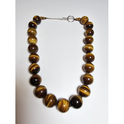 306 - An excellent quality Tigers eye large beaded necklace with a 925 silver clasp featuring 2cm diameter... 