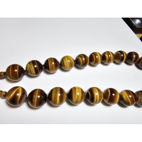 306 - An excellent quality Tigers eye large beaded necklace with a 925 silver clasp featuring 2cm diameter... 