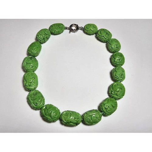 307 - An unusual green turquoise hand carved beaded necklace featuring beautiful carving from each bead pr... 