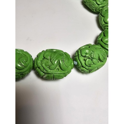 307 - An unusual green turquoise hand carved beaded necklace featuring beautiful carving from each bead pr... 