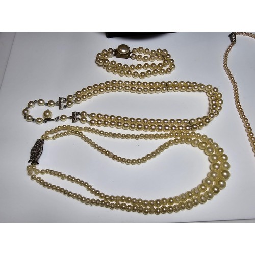 308 - A collection of pearl necklaces to include a good quality genuine pearl beaded necklace with a silve... 