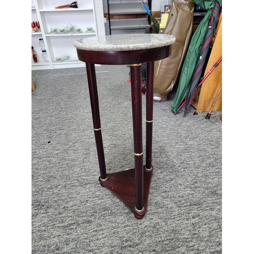 483 - Marble topped jardiniere stand with mahogany pilars standing on bun feet. Height of 66cm x diameter ... 