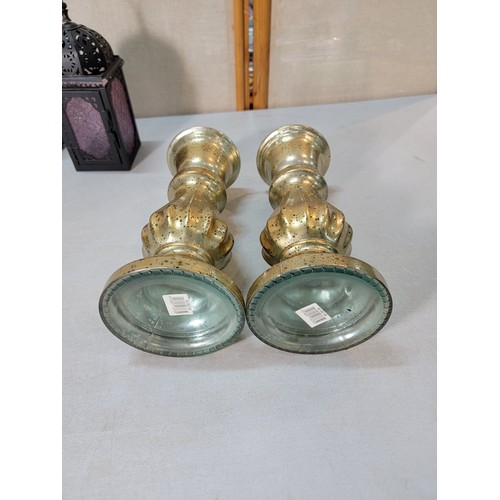 320 - A pair of gold lustre tall glass candlestick holders along with a pair of ornate metal lanterns, 1 w... 