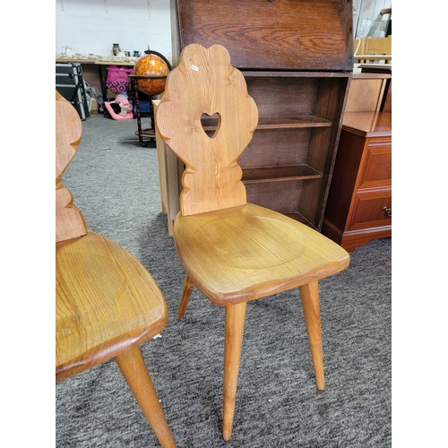 492 - Pair of matching light oak Tyrolean Mid Century chairs both have a carved floral shaped back with a ... 