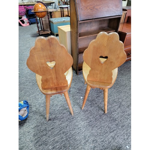 492 - Pair of matching light oak Tyrolean Mid Century chairs both have a carved floral shaped back with a ... 