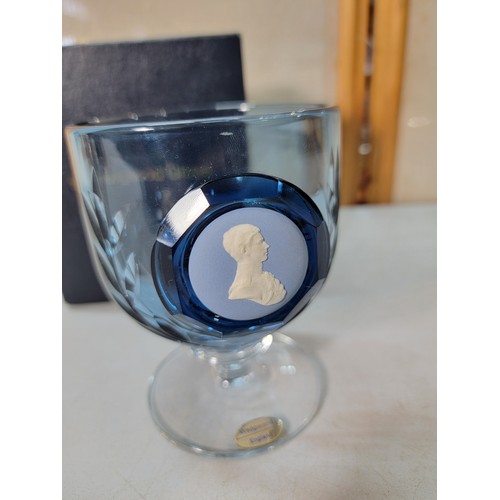 321 - A boxed Wedgwood blue glass jasper cameo goblet along with 4 ceramic character jugs to include a han... 