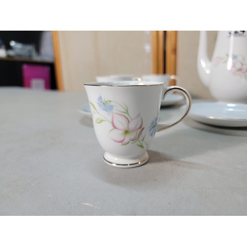 324 - A pretty 11 piece Susie Cooper coffee set in the Day Lily pattern. In excellent clean condition with... 