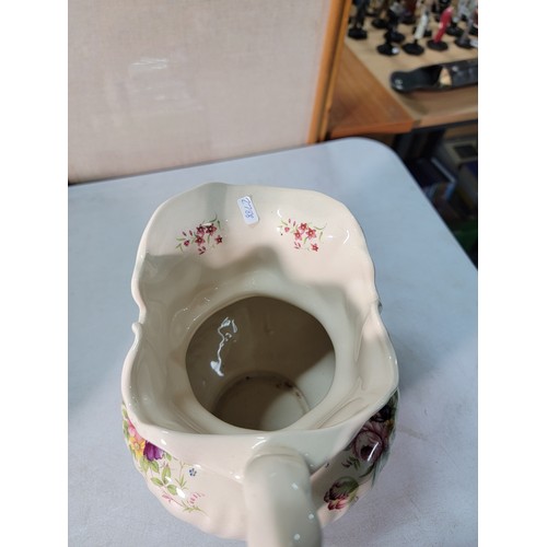 327 - A large vintage ceramic jug and bowl with a hand decorated floral design by Long Mead in excellent c... 