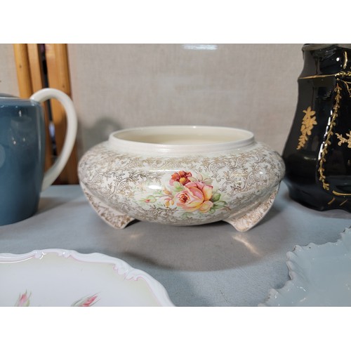 325 - A shelf full of collectable ceramic to include a good Victorian black lidded jug with a gilt design ... 