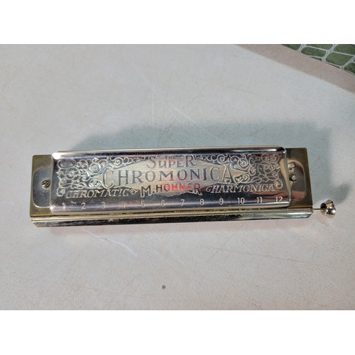 263 - 2x vintage harmonicas which includes a cased harmonica by Hohner titled 