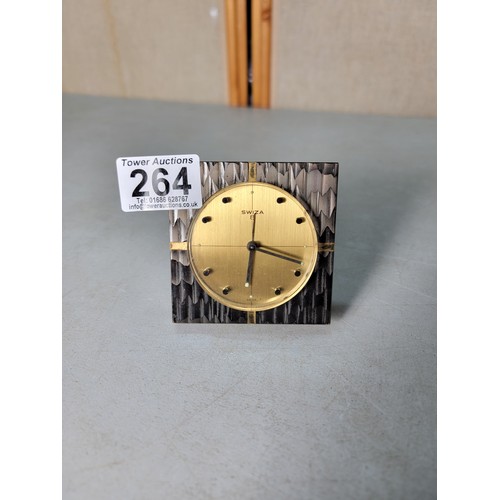 264 - A Swiza 8 mechanical travel alarm clock having an ornate design, in good condition, the clock has be... 