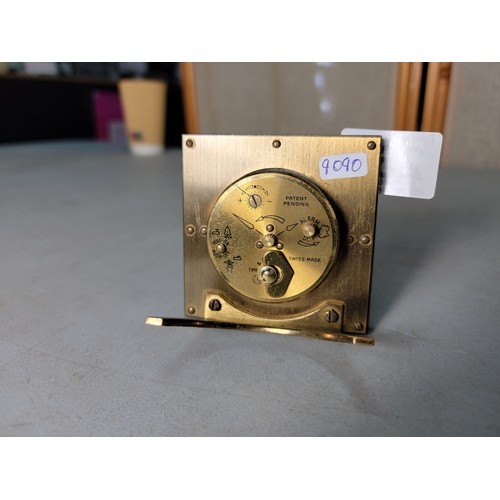 264 - A Swiza 8 mechanical travel alarm clock having an ornate design, in good condition, the clock has be... 