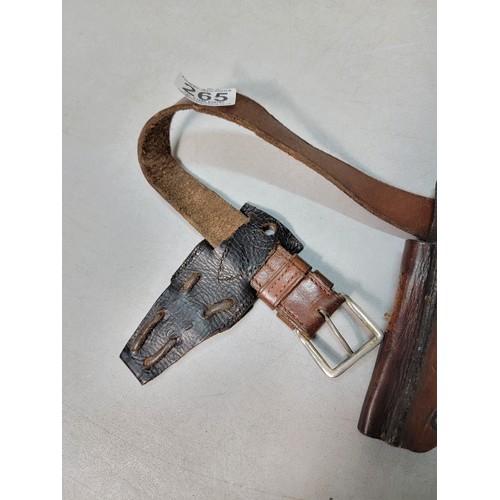 265 - A good quality early vintage or antique full leather handgun holster on a leather belt of good quali... 