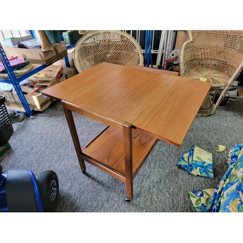 489 - Mid Century Teak drop leaf hostess trollely standing on 4x castors, has a shelf to the base. Height ... 