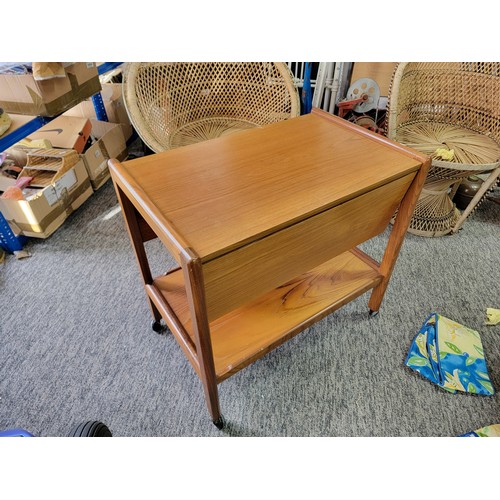 489 - Mid Century Teak drop leaf hostess trollely standing on 4x castors, has a shelf to the base. Height ... 