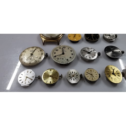 267D - Large quantity of various mechanical watch movements and dials, along with a small button case. To i... 