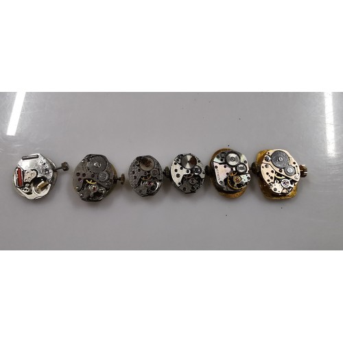 267D - Large quantity of various mechanical watch movements and dials, along with a small button case. To i... 