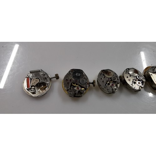 267D - Large quantity of various mechanical watch movements and dials, along with a small button case. To i... 