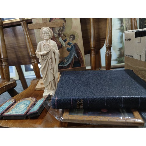 82 - A quantity of various Catholic items to include a Crucifix, painting on board, a Bible, candle holde... 