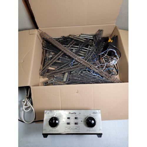 53 - Box containing a large quantity of OO gauge curved and straight track, along with a Duette control u... 