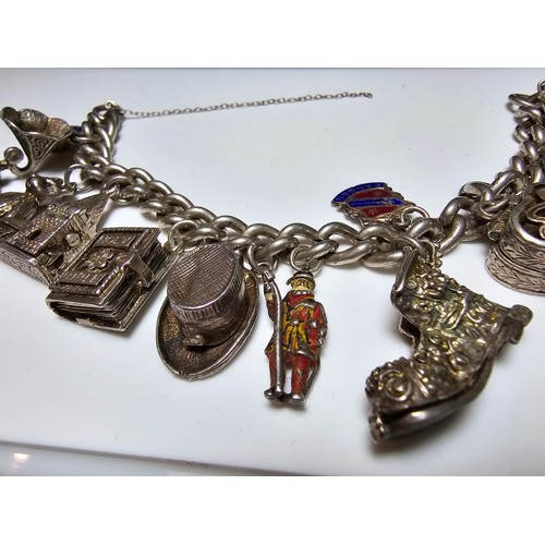 332 - Good quality vintage sterling silver charm bracelet containing 12x sterling silver charms which incl... 