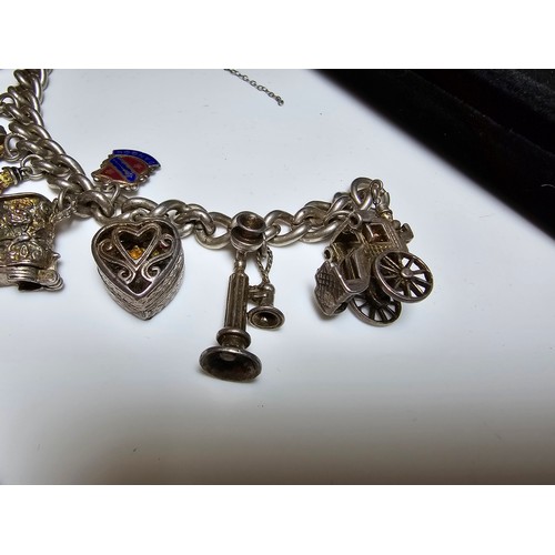 332 - Good quality vintage sterling silver charm bracelet containing 12x sterling silver charms which incl... 